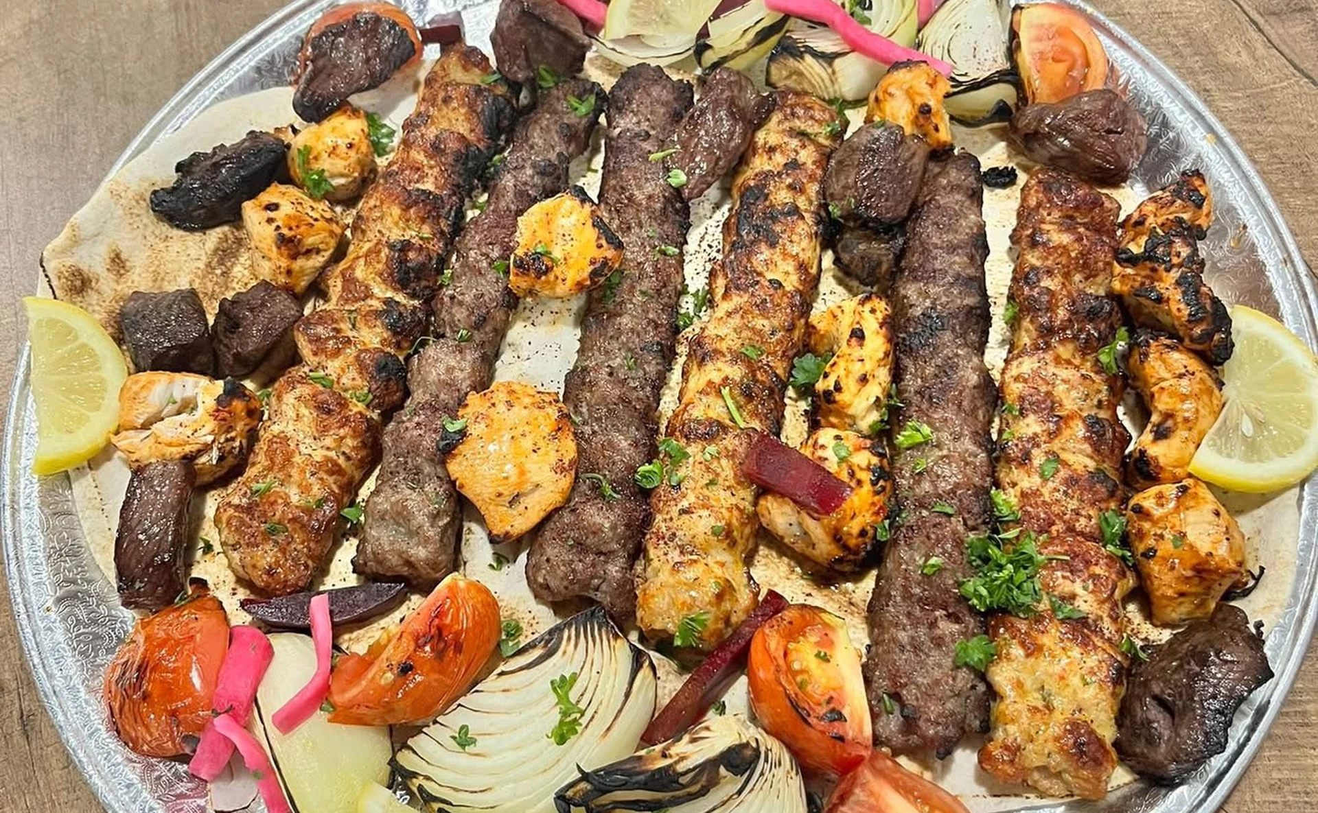 Mixed grill platter of beef and chicken kabobs and chicken tikka at Mashawi Market & Grill in east Calgary